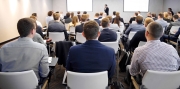 Group of people at the business conference, back view. Row of business people  listen to the speaker on the forum or at seminar in modern conference room.
