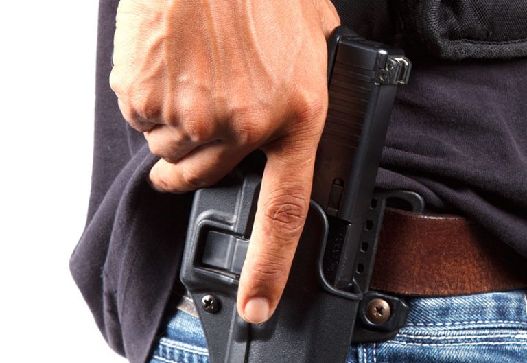 hand on gun in holster