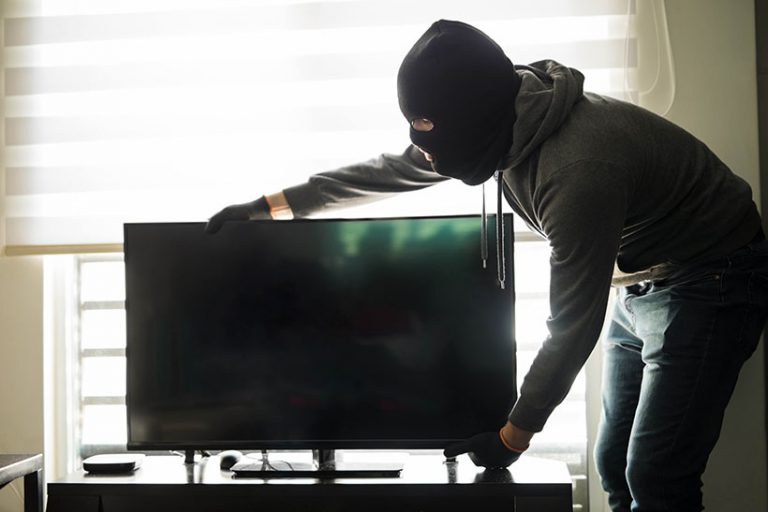man stealing a TV